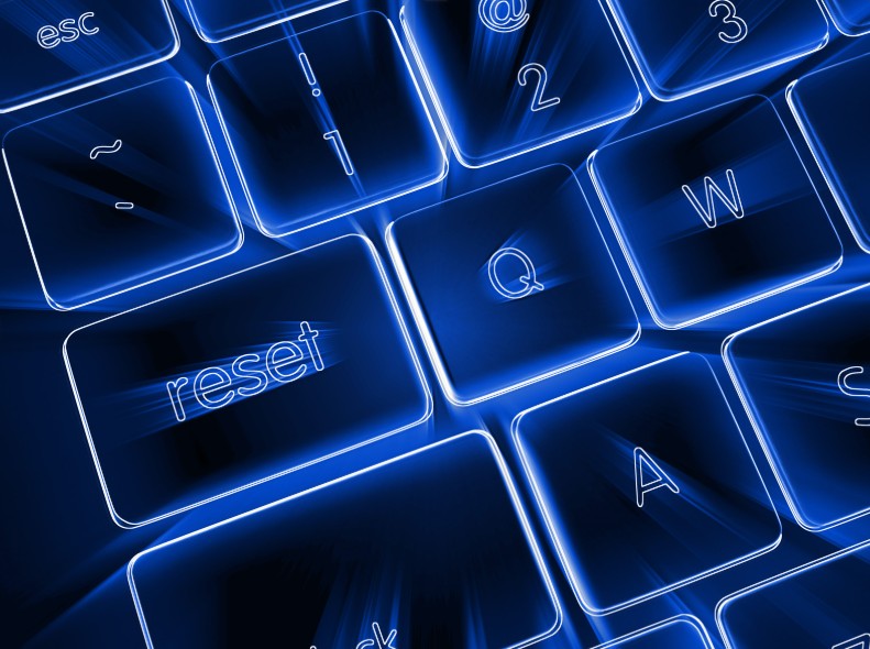 A glowing blue keyboard with a highlighted “reset” key, symbolizing a business returning to clarity during the monthly close.